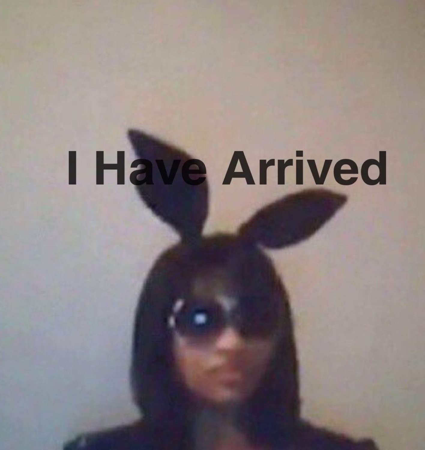 Person in bunny ears and dark sunglasses posing dramatically under 'I Have Arrived'
