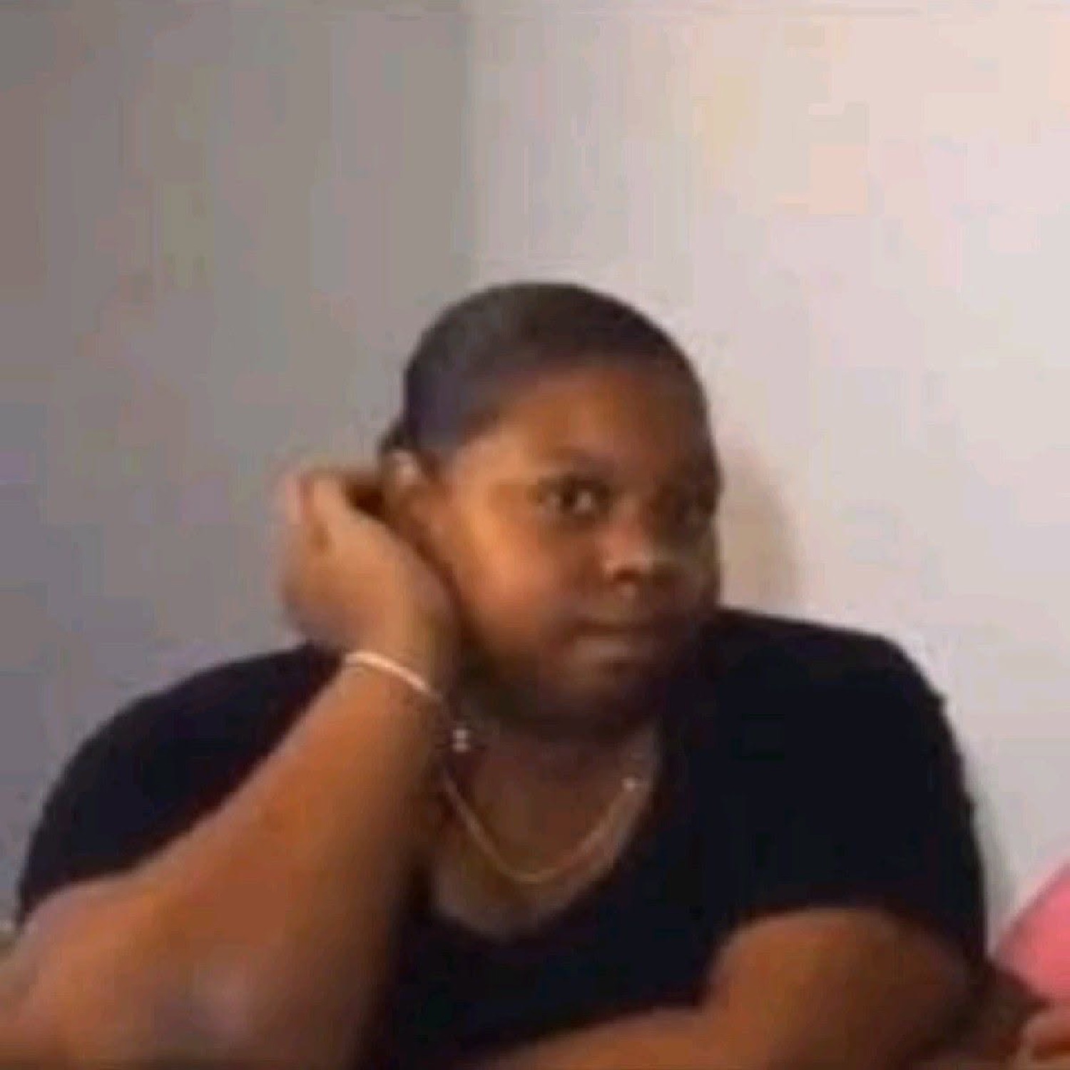 Woman with a hand cupped to her ear giving a skeptical sideways look