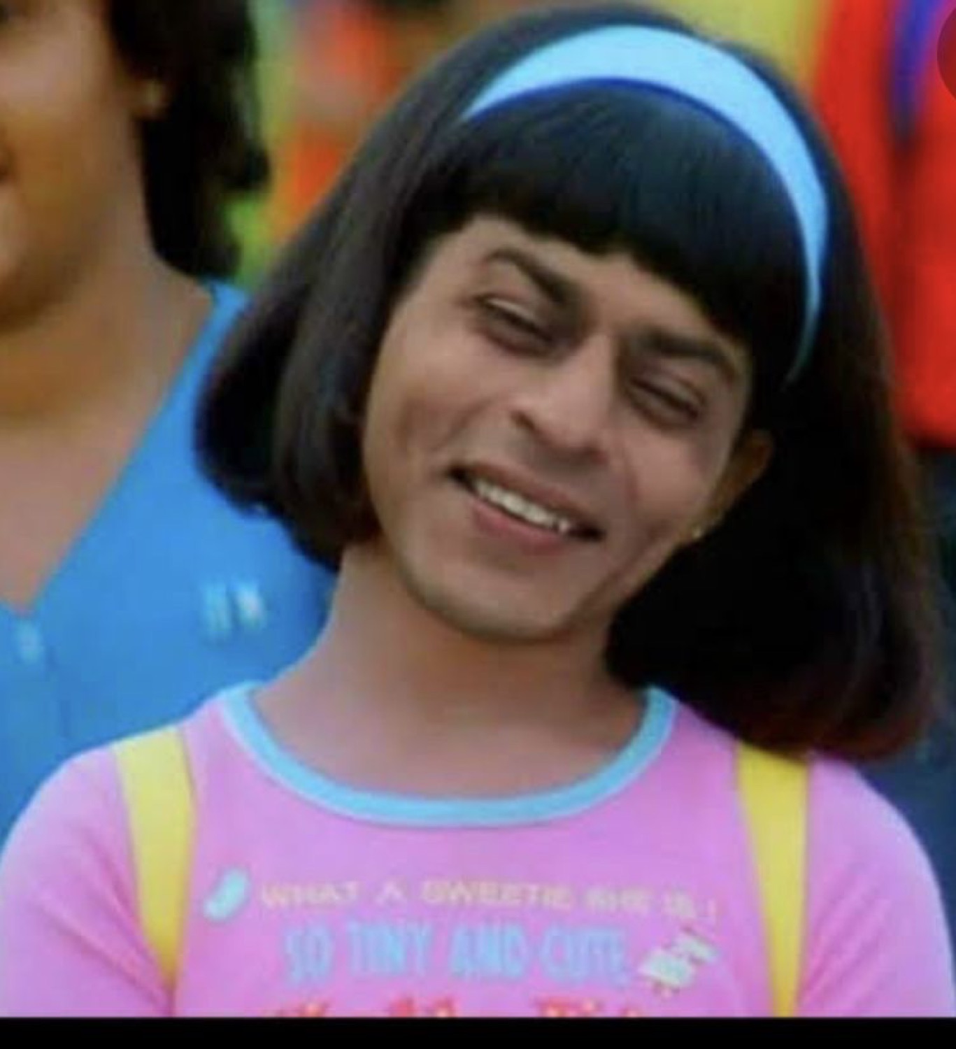 Shah Rukh Khan in a bob wig and headband grinning