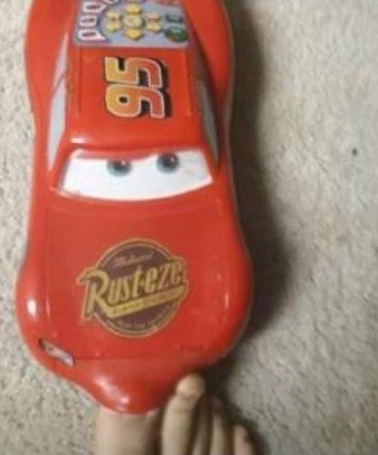 Squished McQueen toy staring blankly