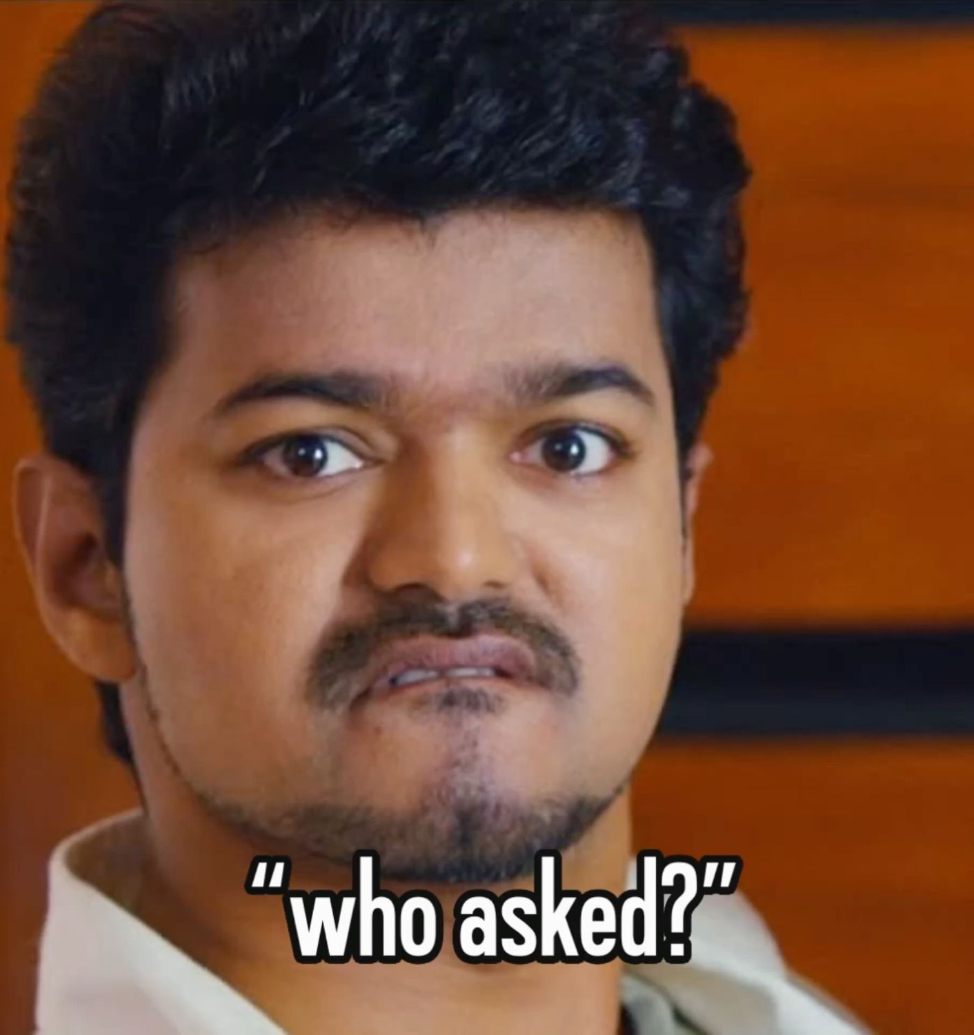Close-up of Vijay with a sour pout: '"who asked?"'
