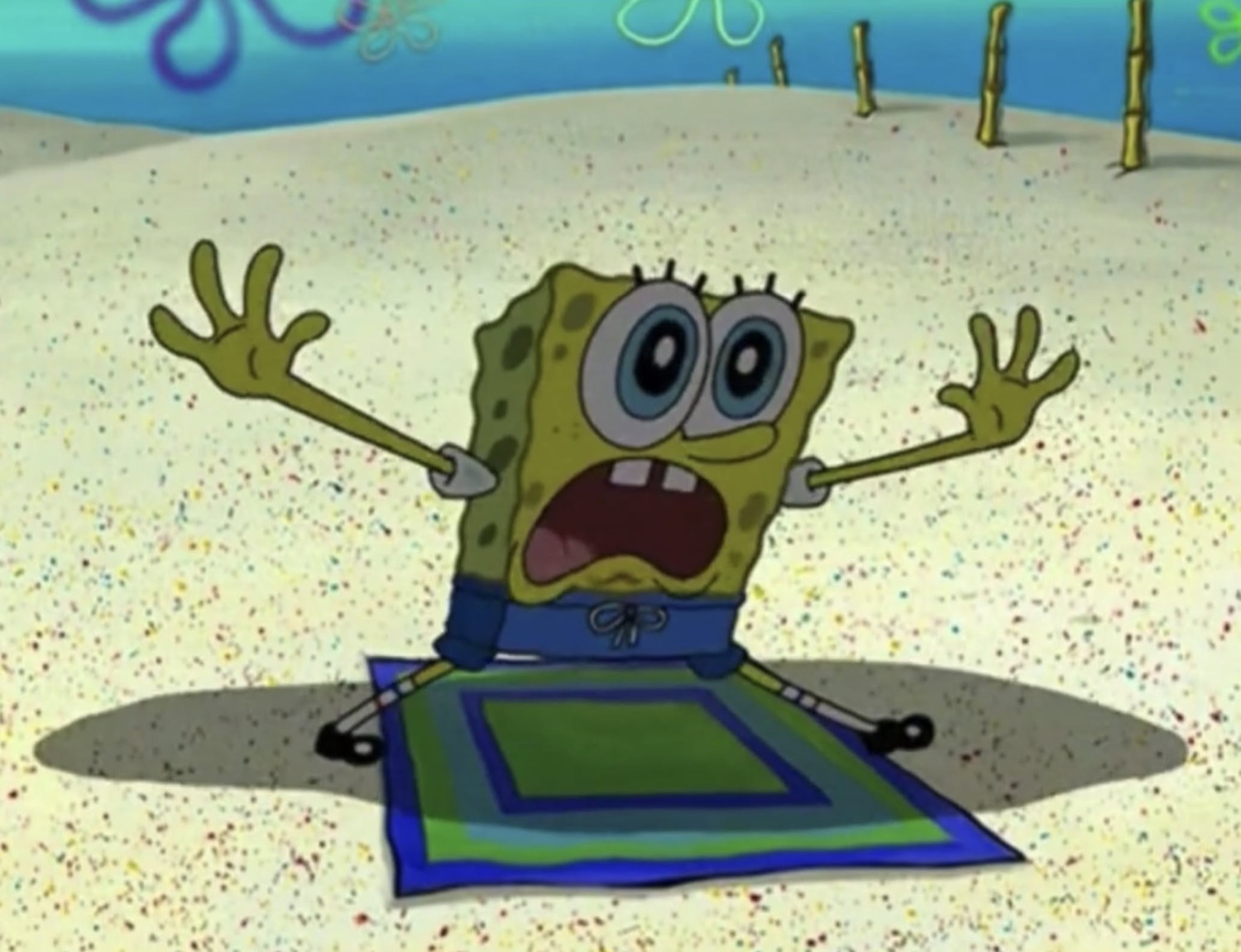 SpongeBob buried in the sand screaming with arms flailing in despair