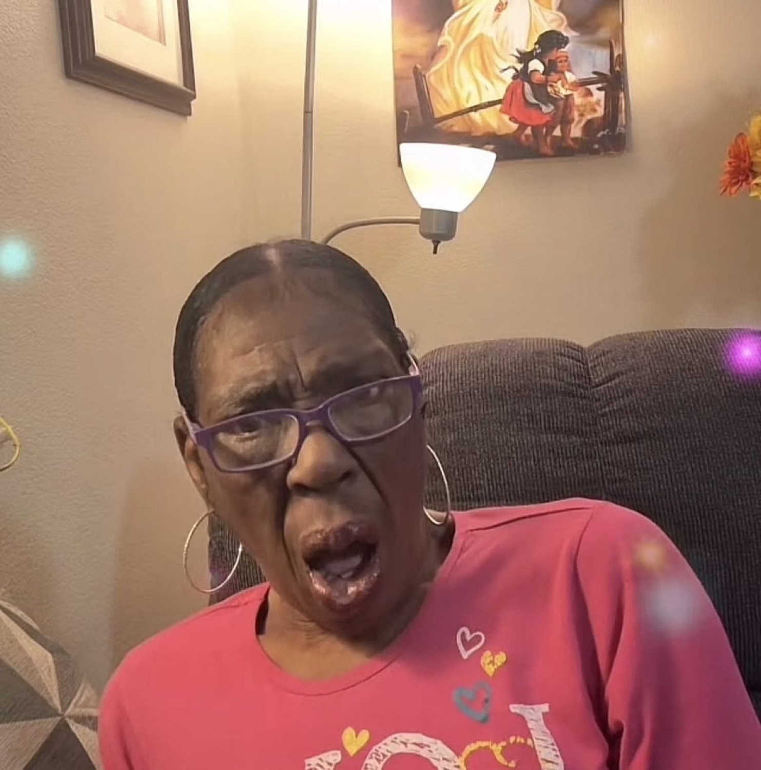 Elderly woman in pink shirt reacting with mouth wide open in shocked disbelief