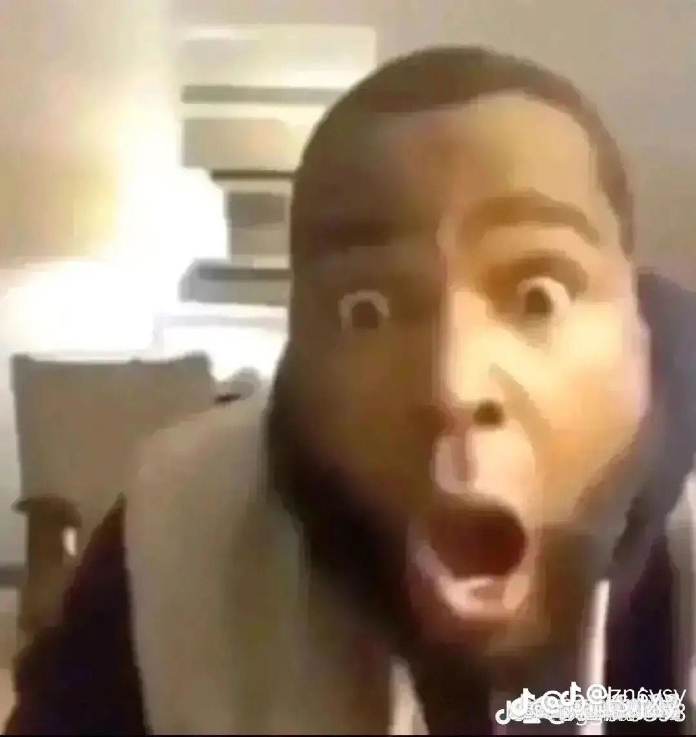 Man staring into the camera with a cartoonishly huge wide-eyed shocked expression