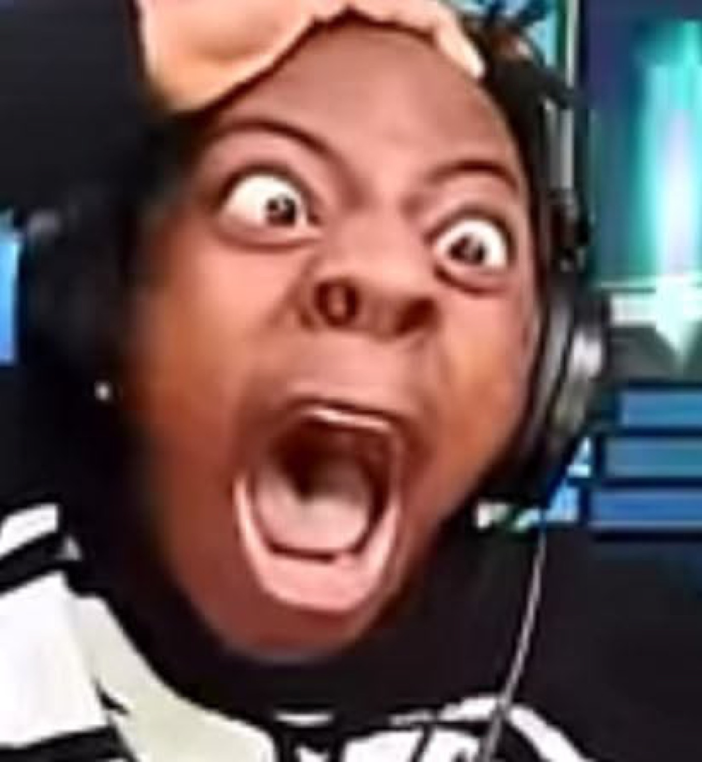 Streamer reacting with wide-eyed, open-mouthed shock, hand on head, absolutely losing it