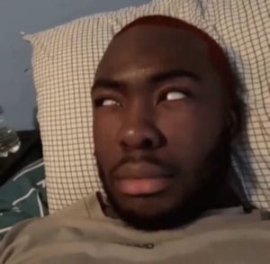 Man lying on a pillow rolling his eyes back with a totally over-it look
