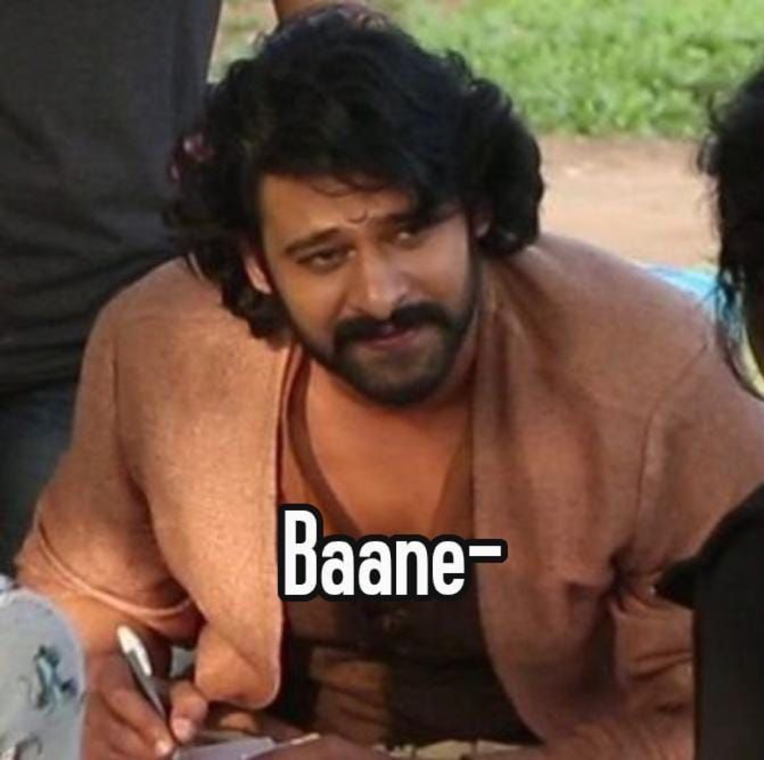 Prabhas leaning in with a sly grin: 'Baane-' (nice)