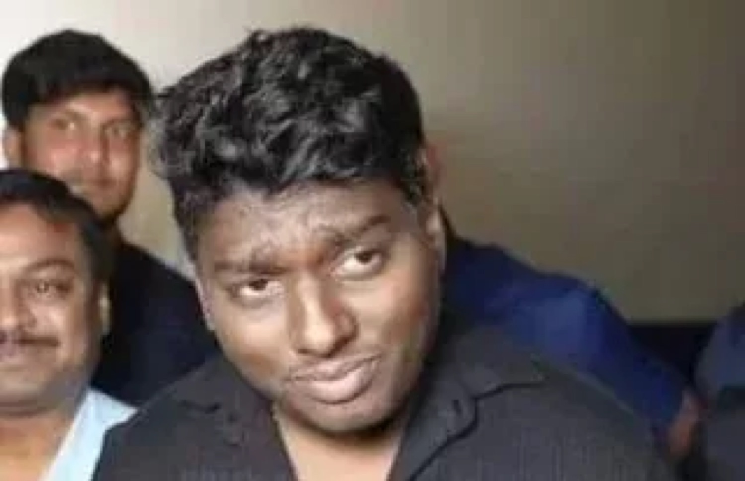 Man raising an eyebrow with a suspicious smirk