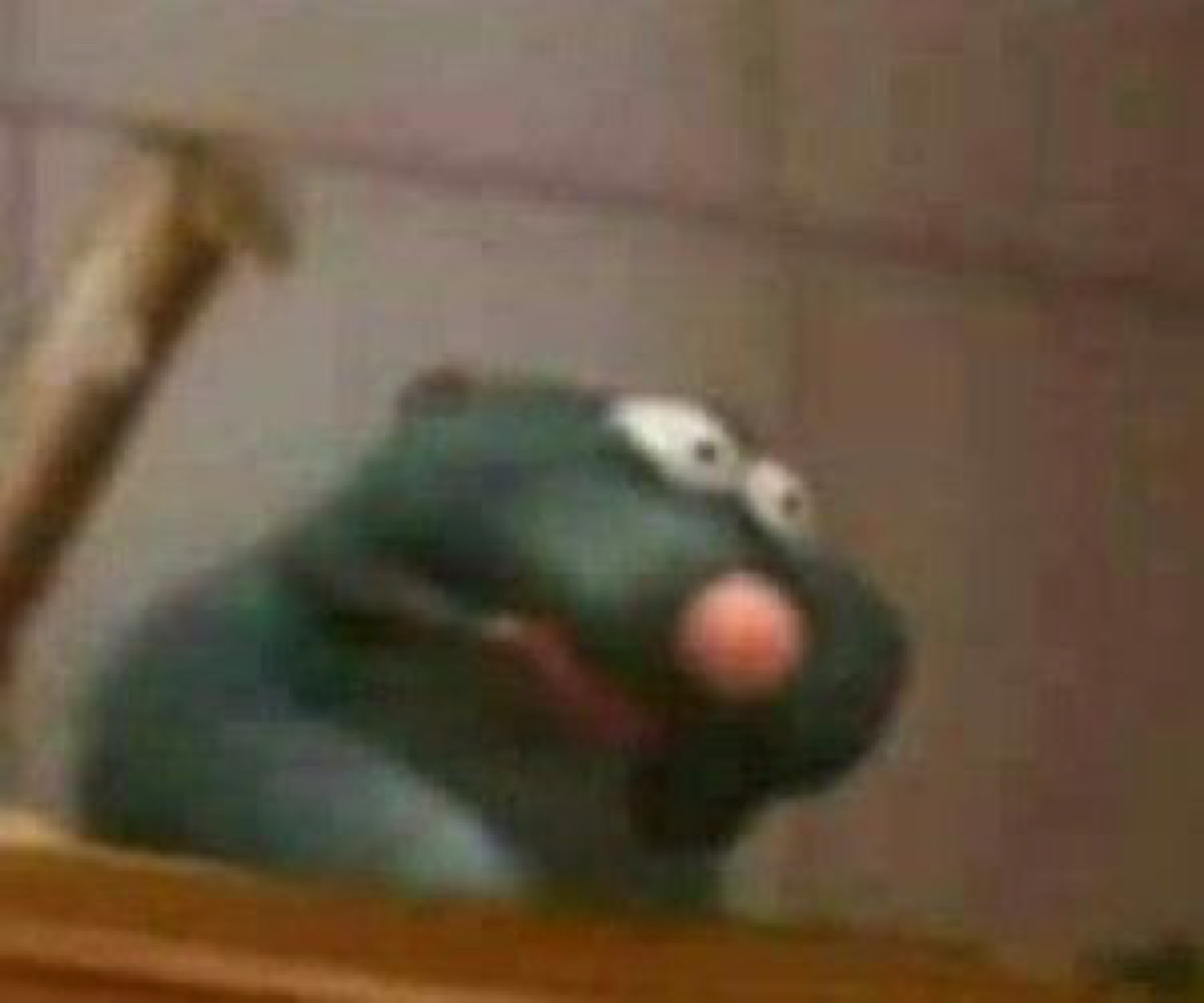 Kermit the Frog slumped over a railing looking utterly defeated