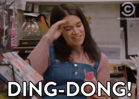 Woman in a denim dress saluting, "Ding-dong!"