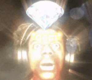 Man staring up open-mouthed as a glowing diamond 'gem' beams over his head