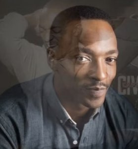 Anthony Mackie looking calm and reflective with a ghost image layered behind him