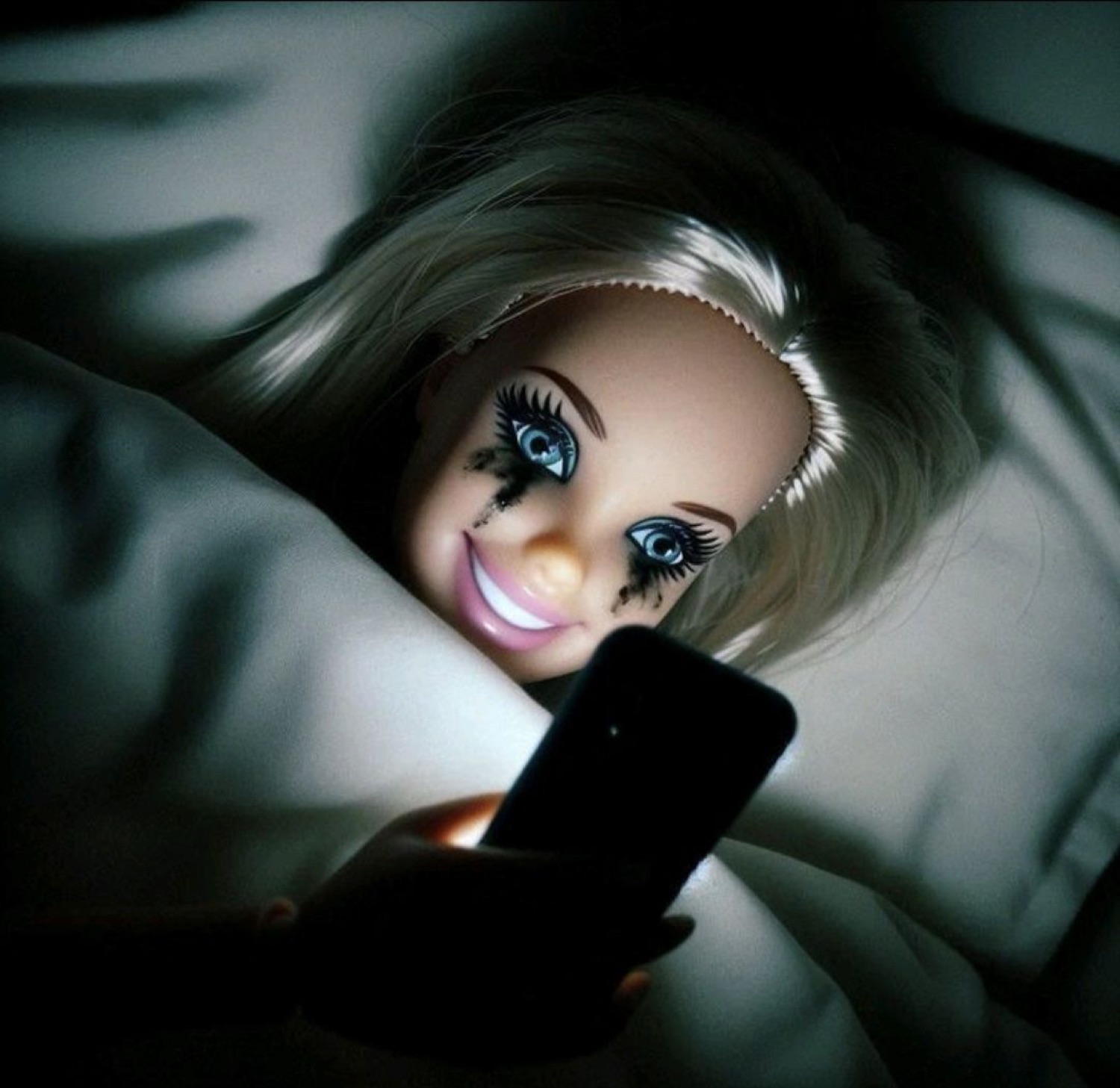 Barbie doll with smeared mascara scrolling her phone in bed at 3am looking unhinged