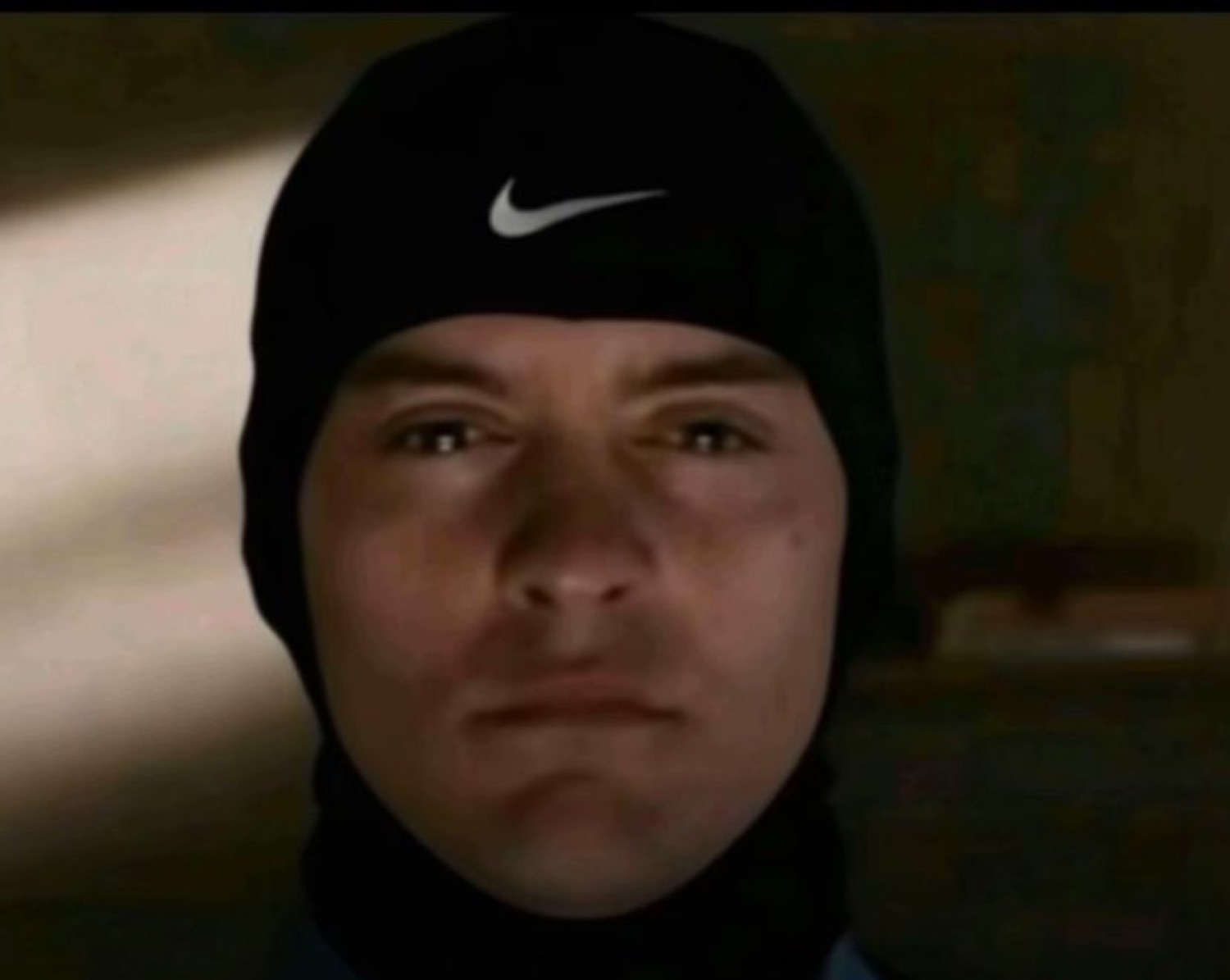 Tobey Maguire in a ski mask with a blank stare