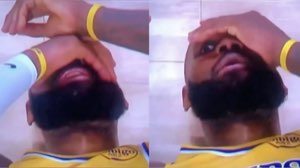 Basketball player lying on the court rubbing his face with both hands in disbelief