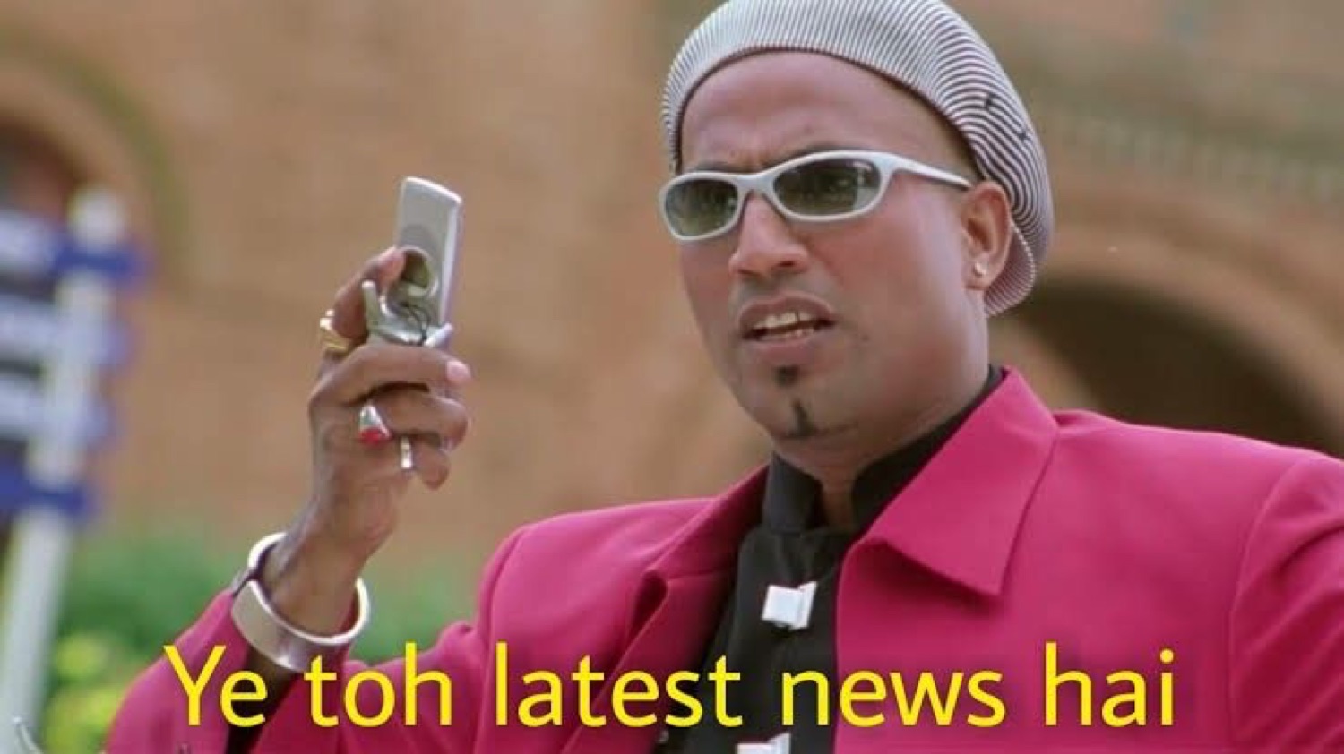 Man in a skullcap and shades holding a flip phone: 'Ye toh latest news hai'