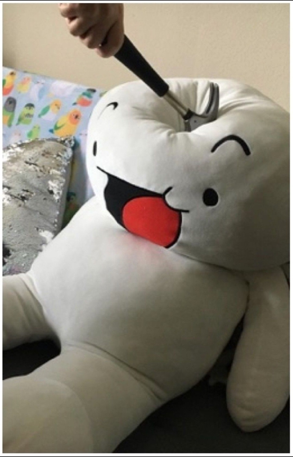 Hand bonking a big white derpy plush on the head with a stick