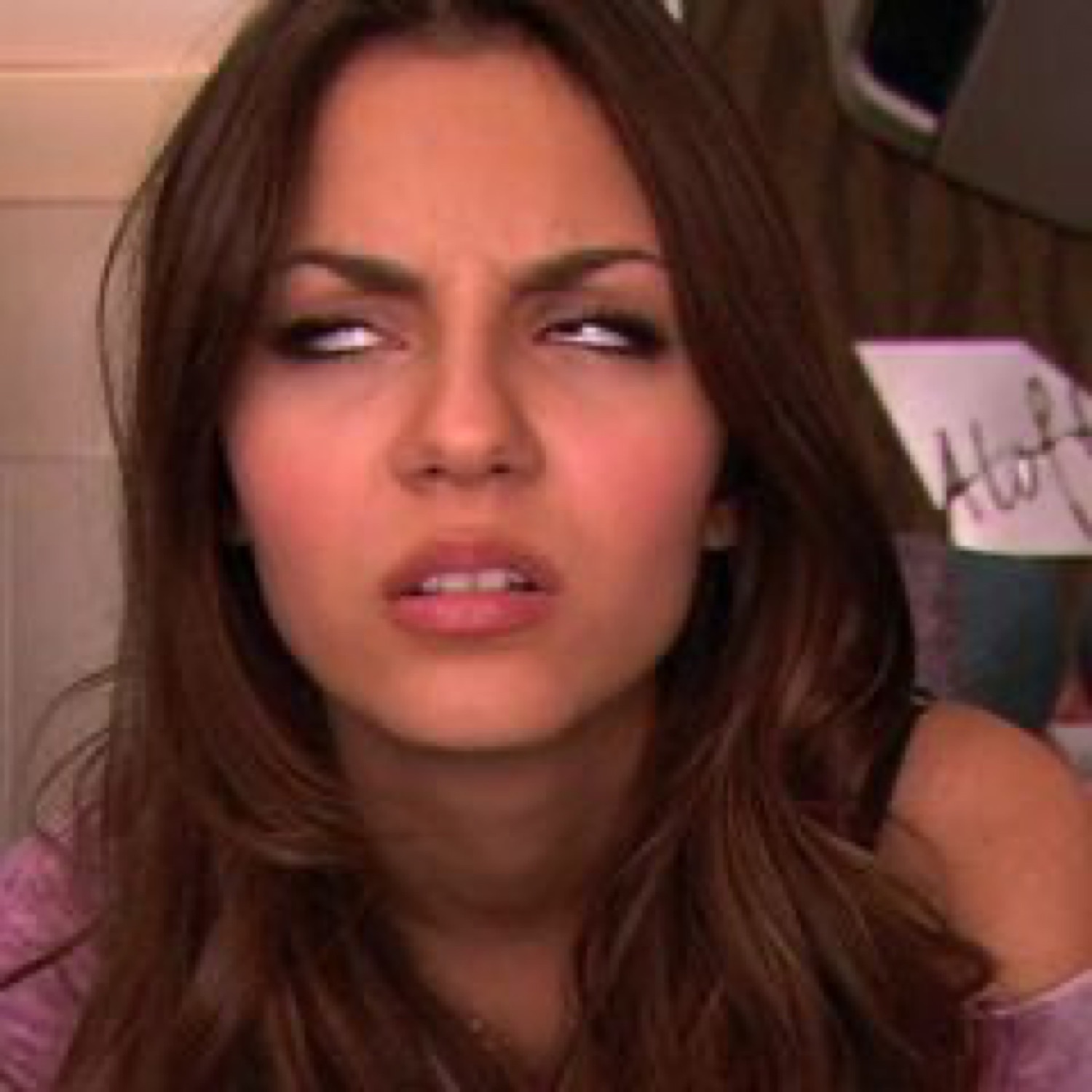 Brunette woman squinting hard with a pursed lip like she just heard the most questionable thing