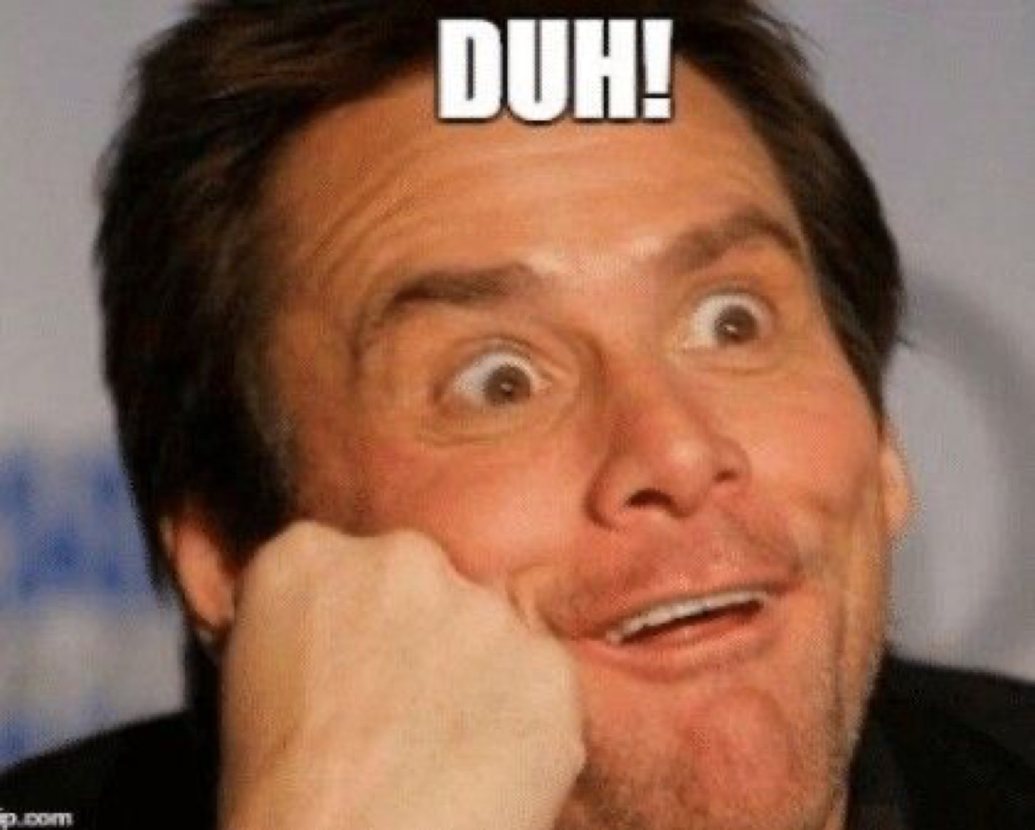 Jim Carrey resting his face on his hand with a goofy grin: 'DUH!'