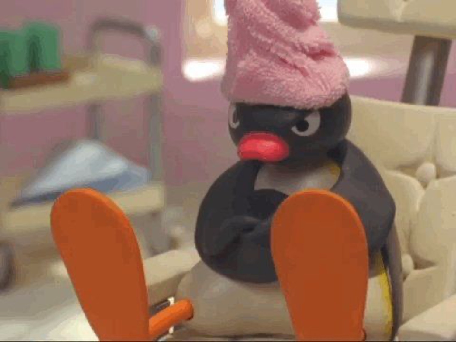 Pingu the penguin slumped in a chair with a towel on his head, arms crossed, thoroughly over it