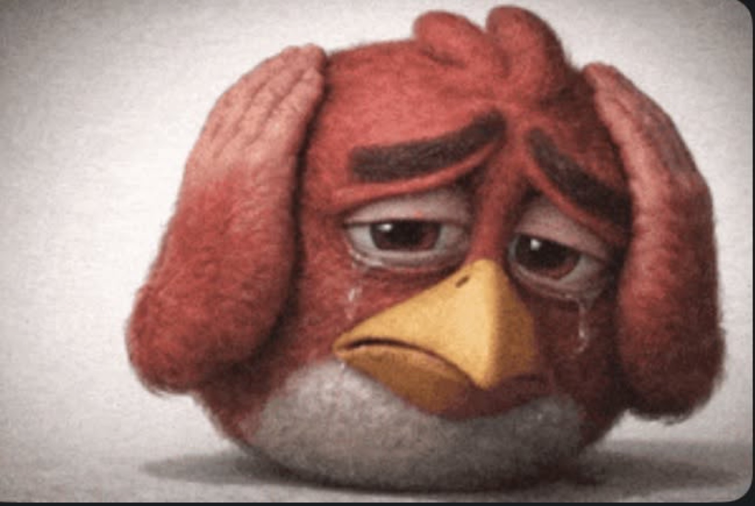 The Angry Birds red bird holding its head and crying with an exhausted, defeated face
