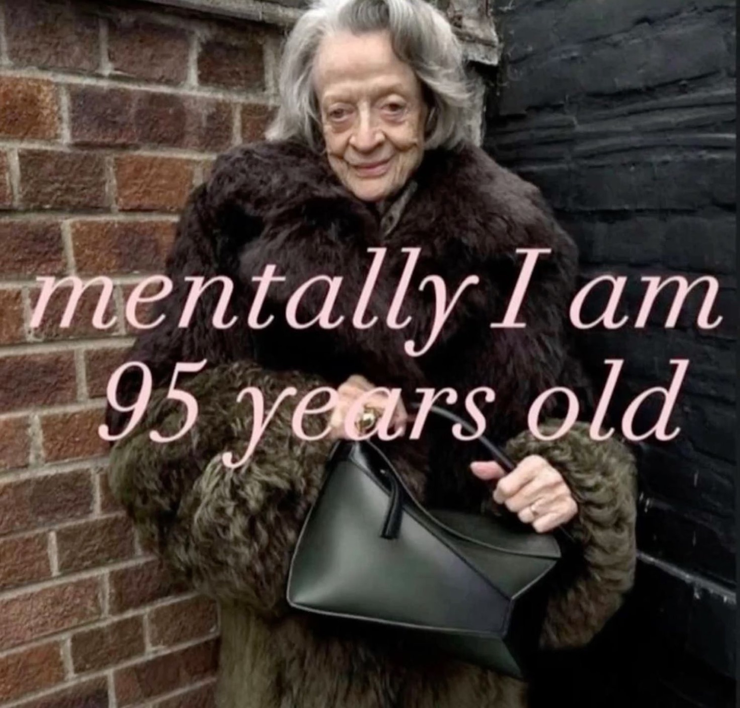 Maggie Smith in a fur coat smirking against a brick wall under 'mentally I am 95 years old'