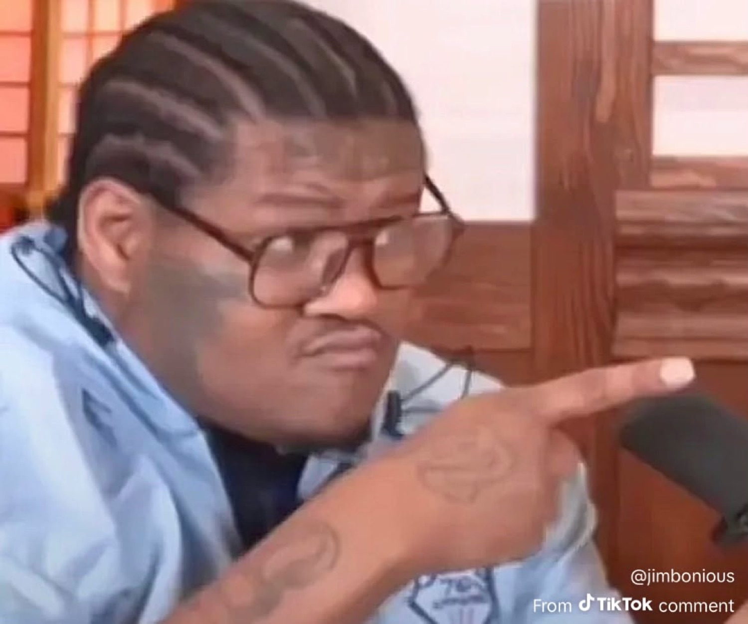Guy in glasses pointing and squinting suspiciously