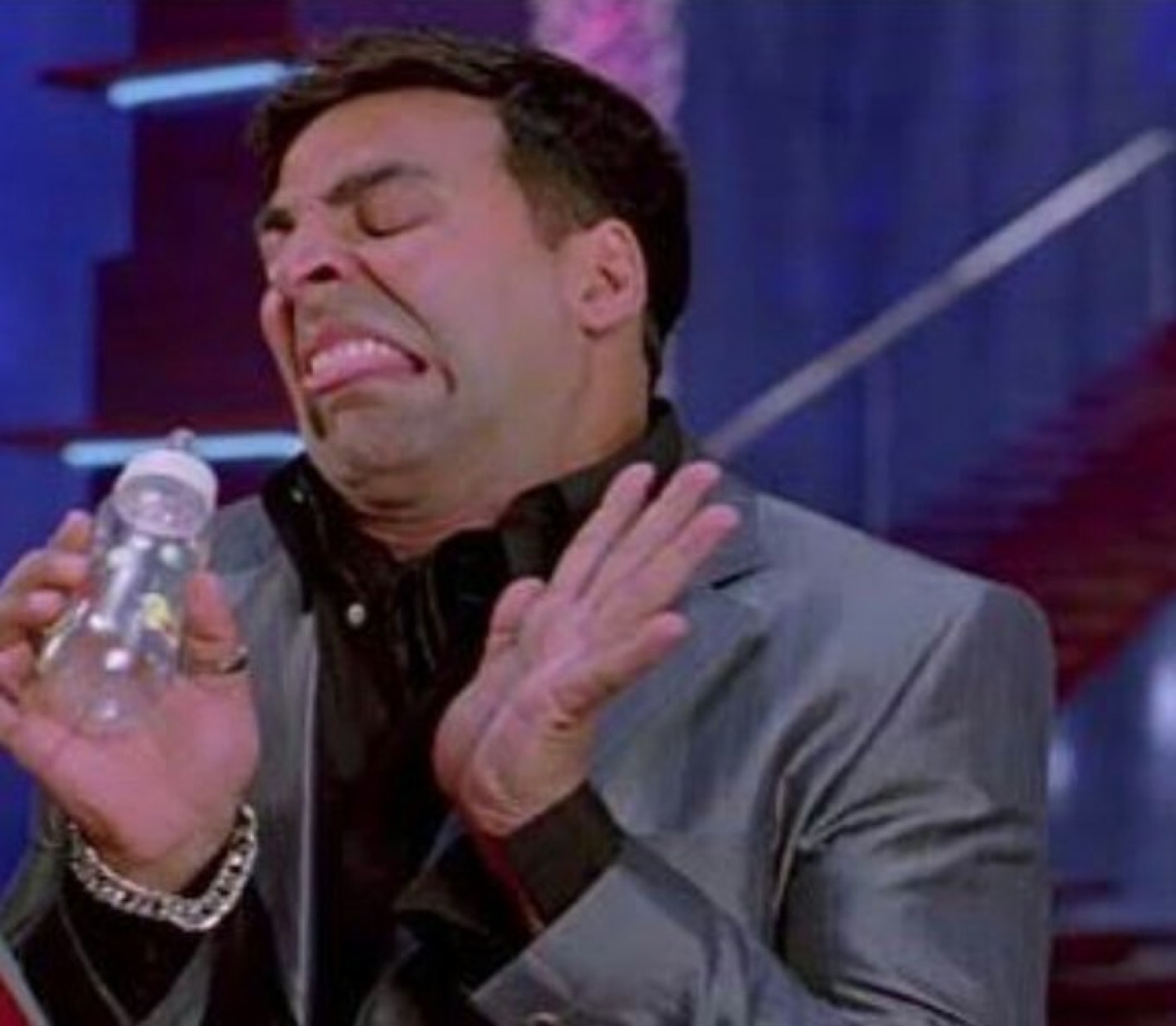Akshay Kumar crying and waving a baby bottle away