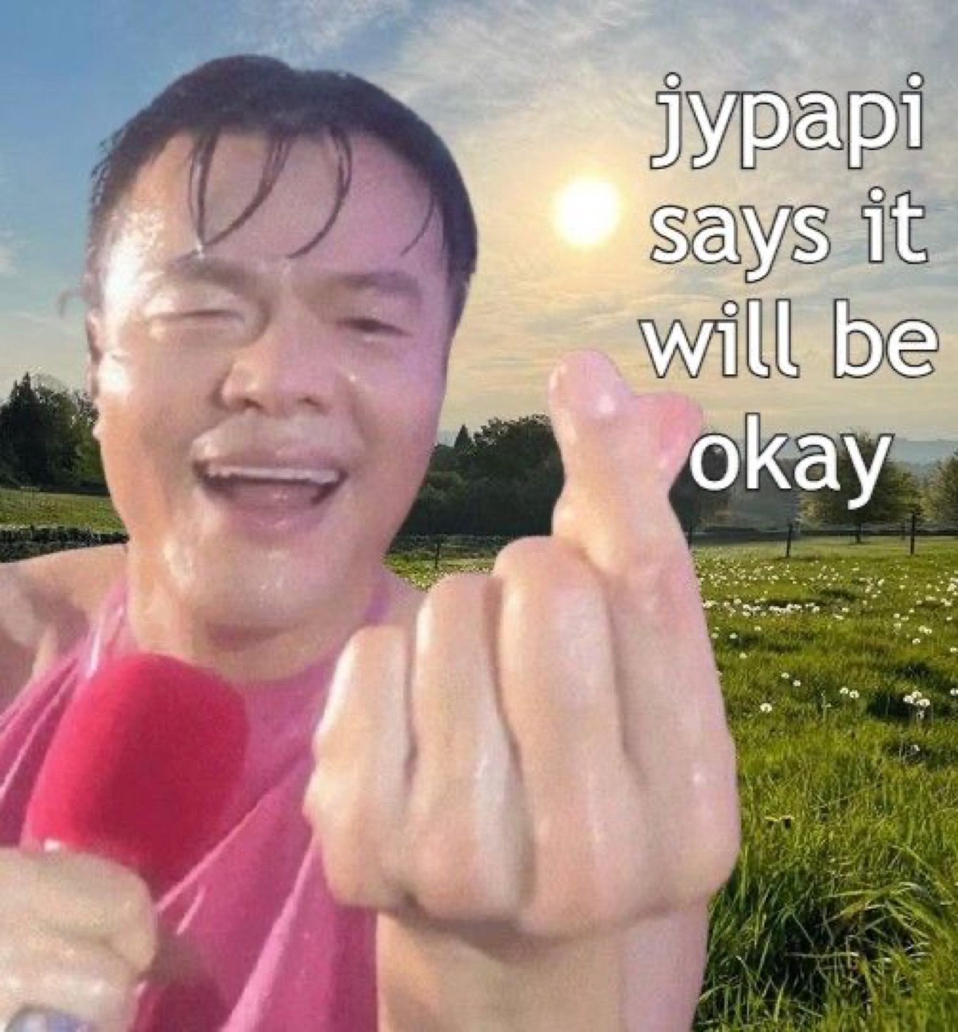 Wet man making a finger heart in a field, captioned 'jypapi says it will be okay'