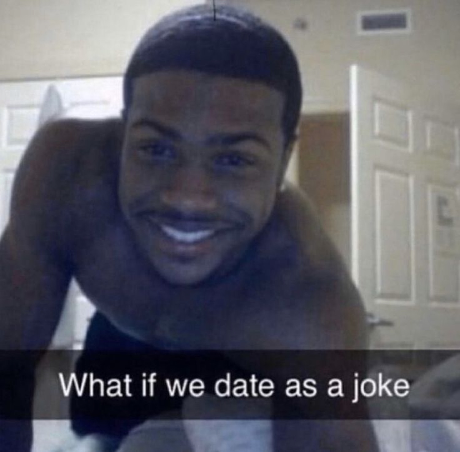 Shirtless guy grinning into the camera over 'What if we date as a joke'