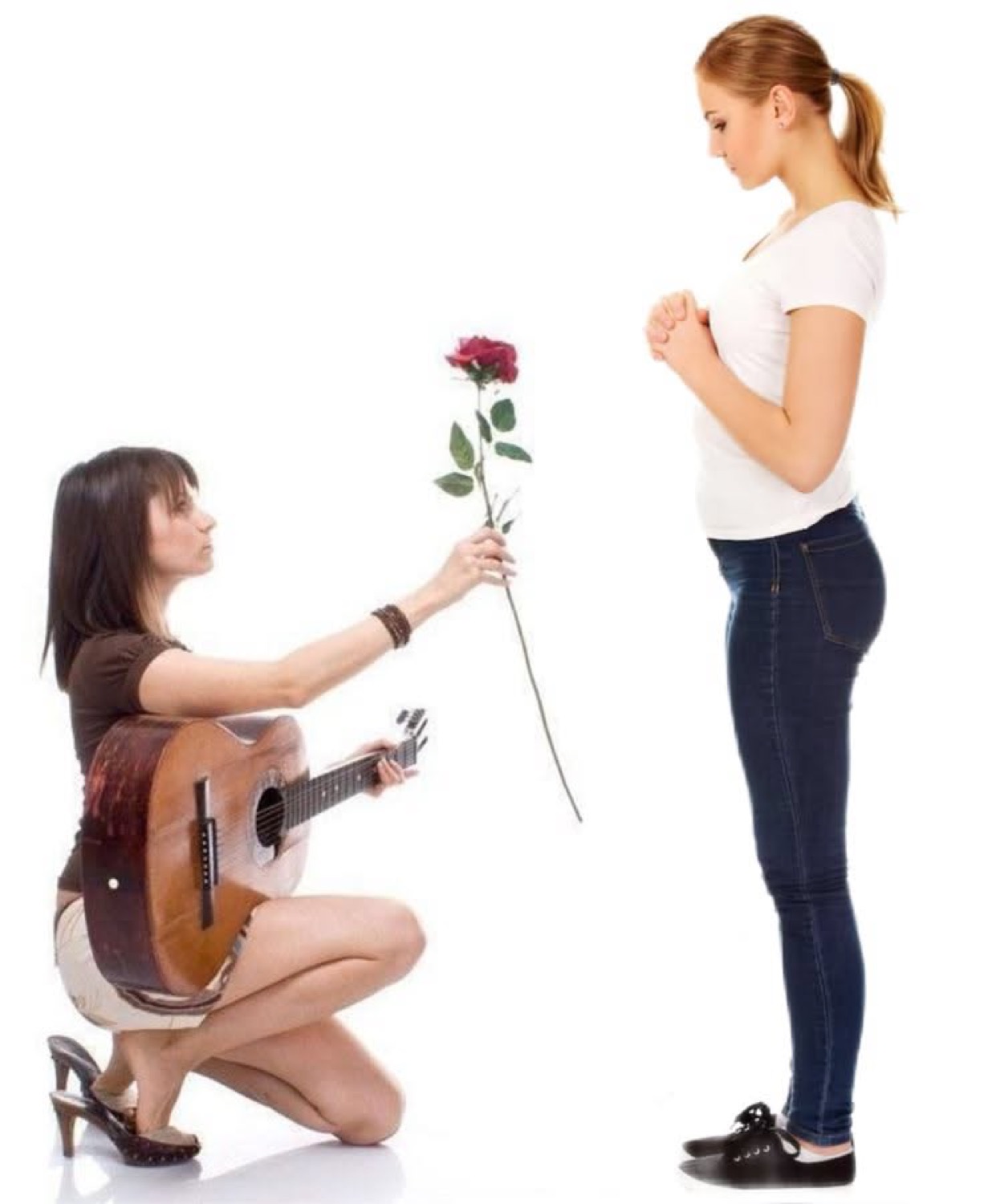 Woman kneeling with a guitar holding out a rose to another woman on a white background
