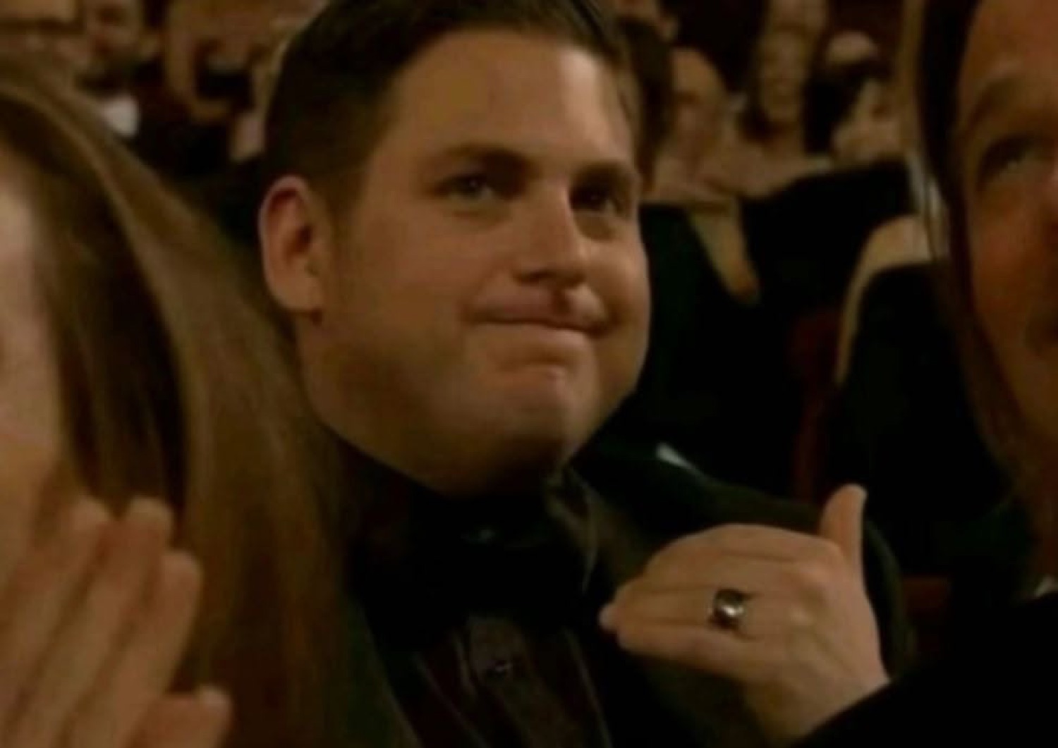 Jonah Hill in the audience, smirking with a thumbs up