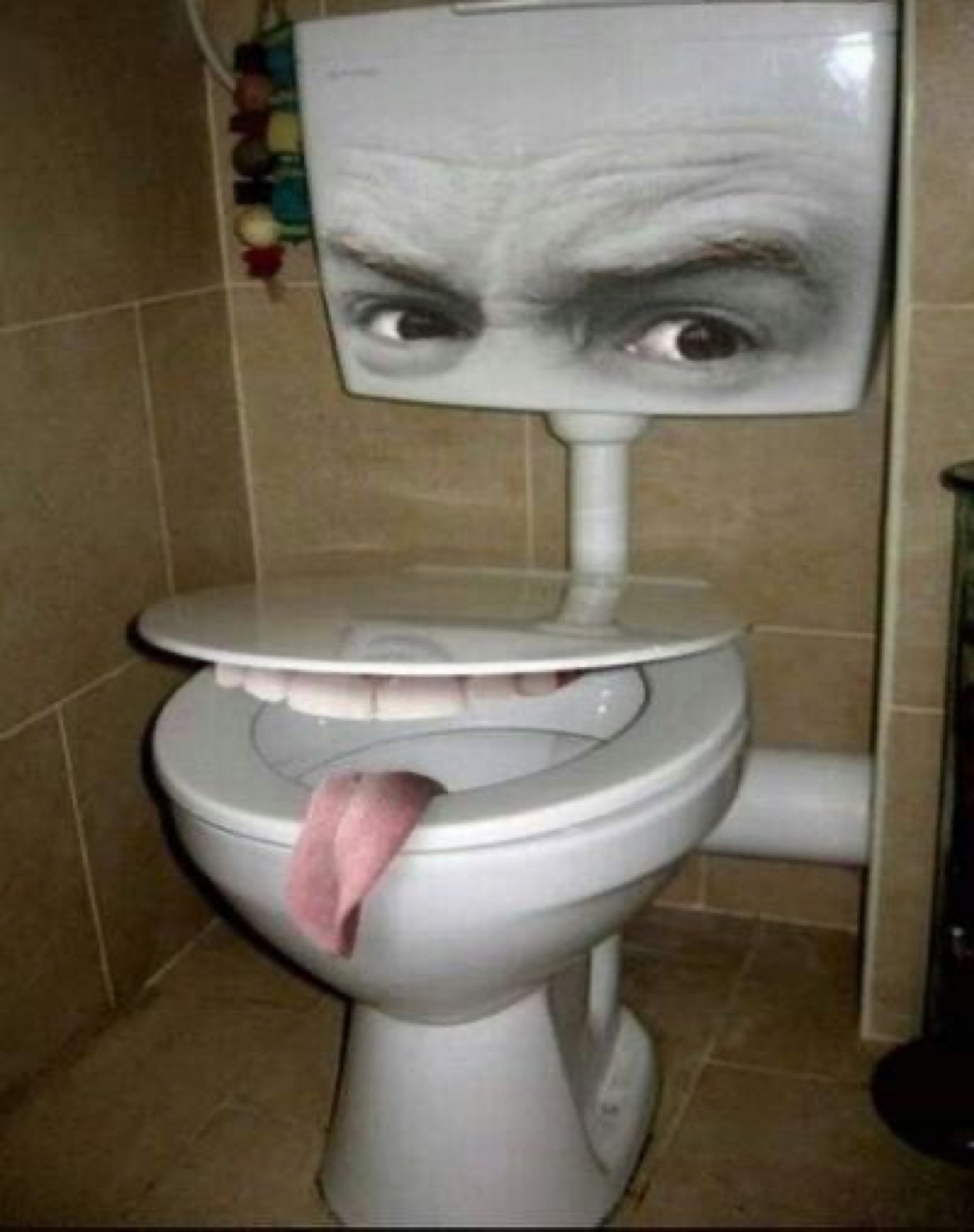 Toilet with angry eyebrows and a tongue sticking out of the seat