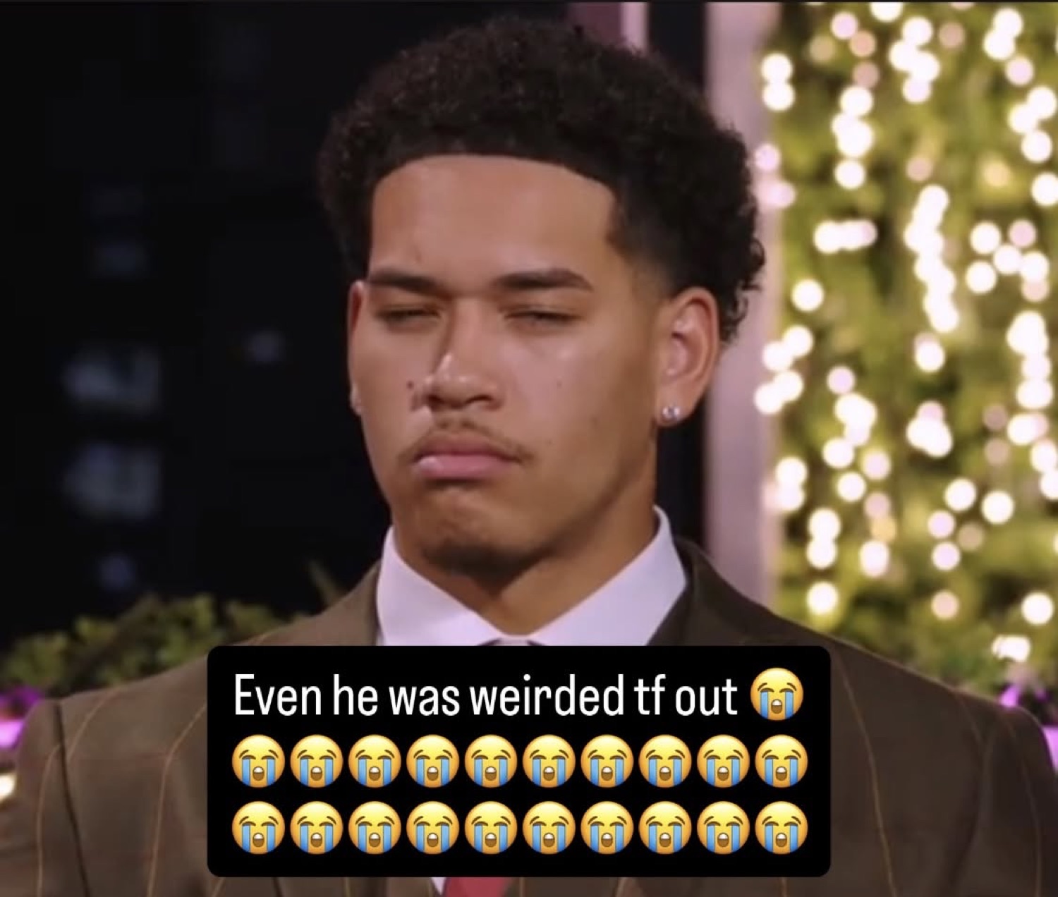 Love Island USA's Corbin squinting skeptically in a suit under 'Even he was weirded tf out ๐ญ'
