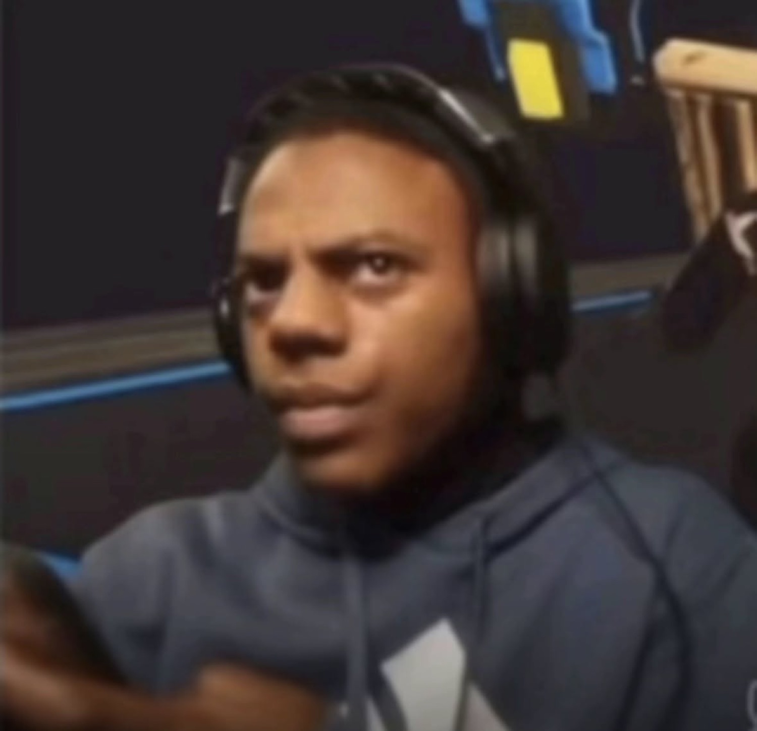 Guy in headphones frowning and squinting with a confused, annoyed look