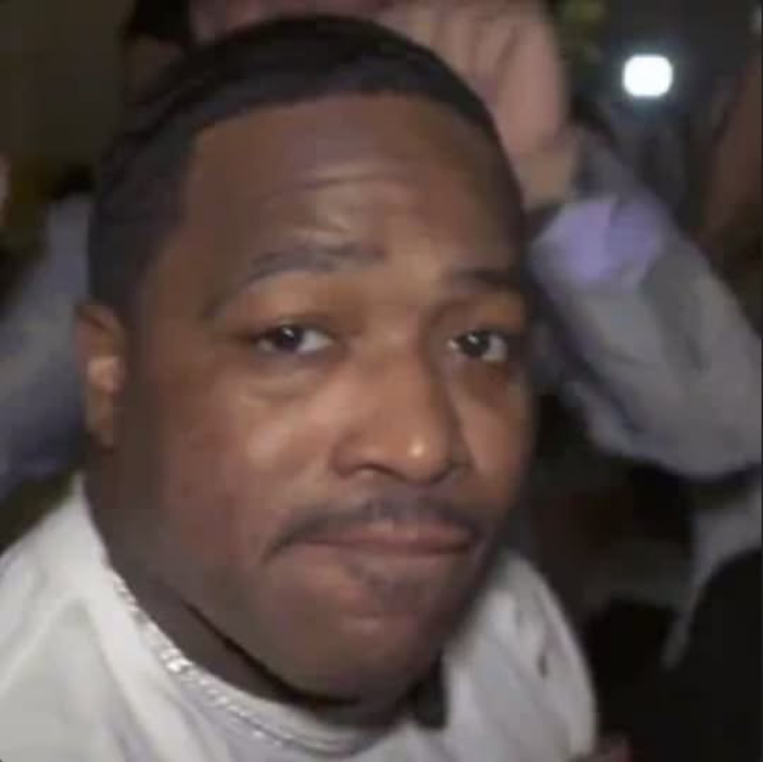 Close-up of a man with a slow, smug half-smile