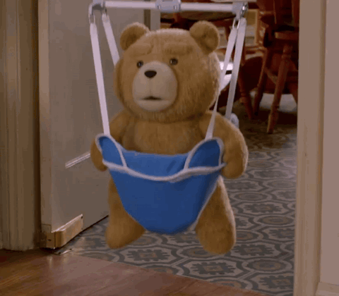 Ted the teddy bear bouncing in a baby jumper