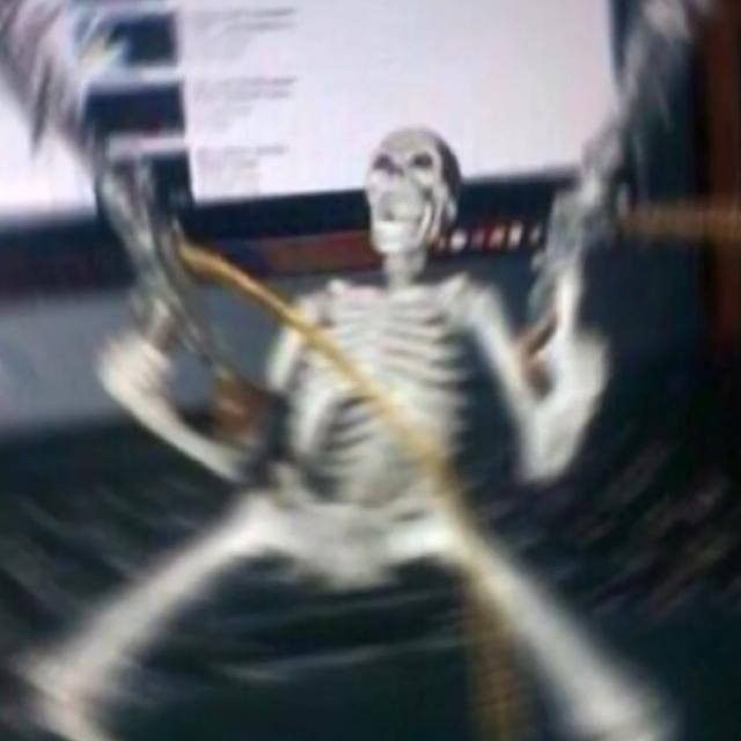 Blurry skeleton flailing wildly in front of a screen