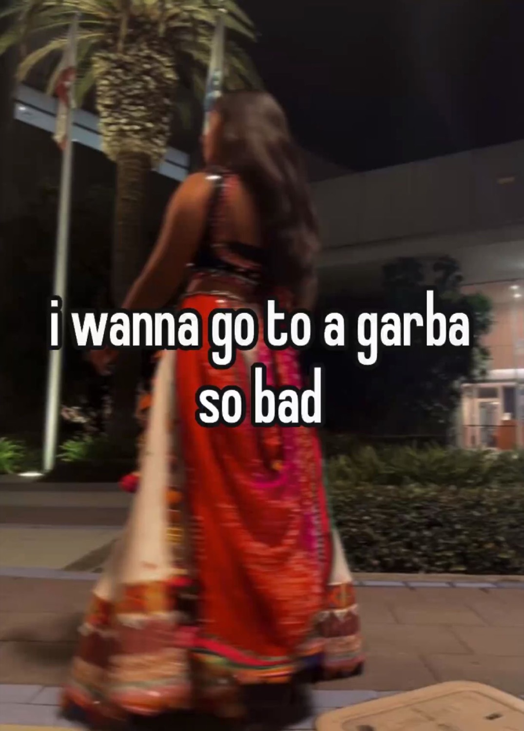 Woman in a red chaniya choli from behind: 'i wanna go to a garba so bad'