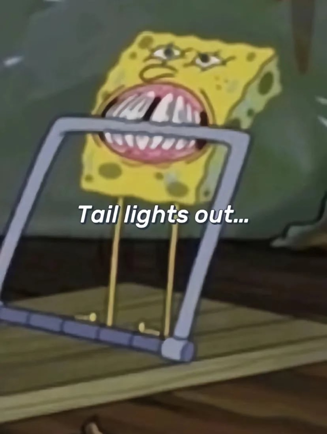 SpongeBob's face stuck in a glass frame on a tricycle under 'Tail lights out...'