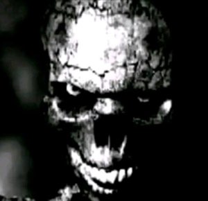 Grainy black-and-white skull face screaming out of the darkness — nightmare fuel