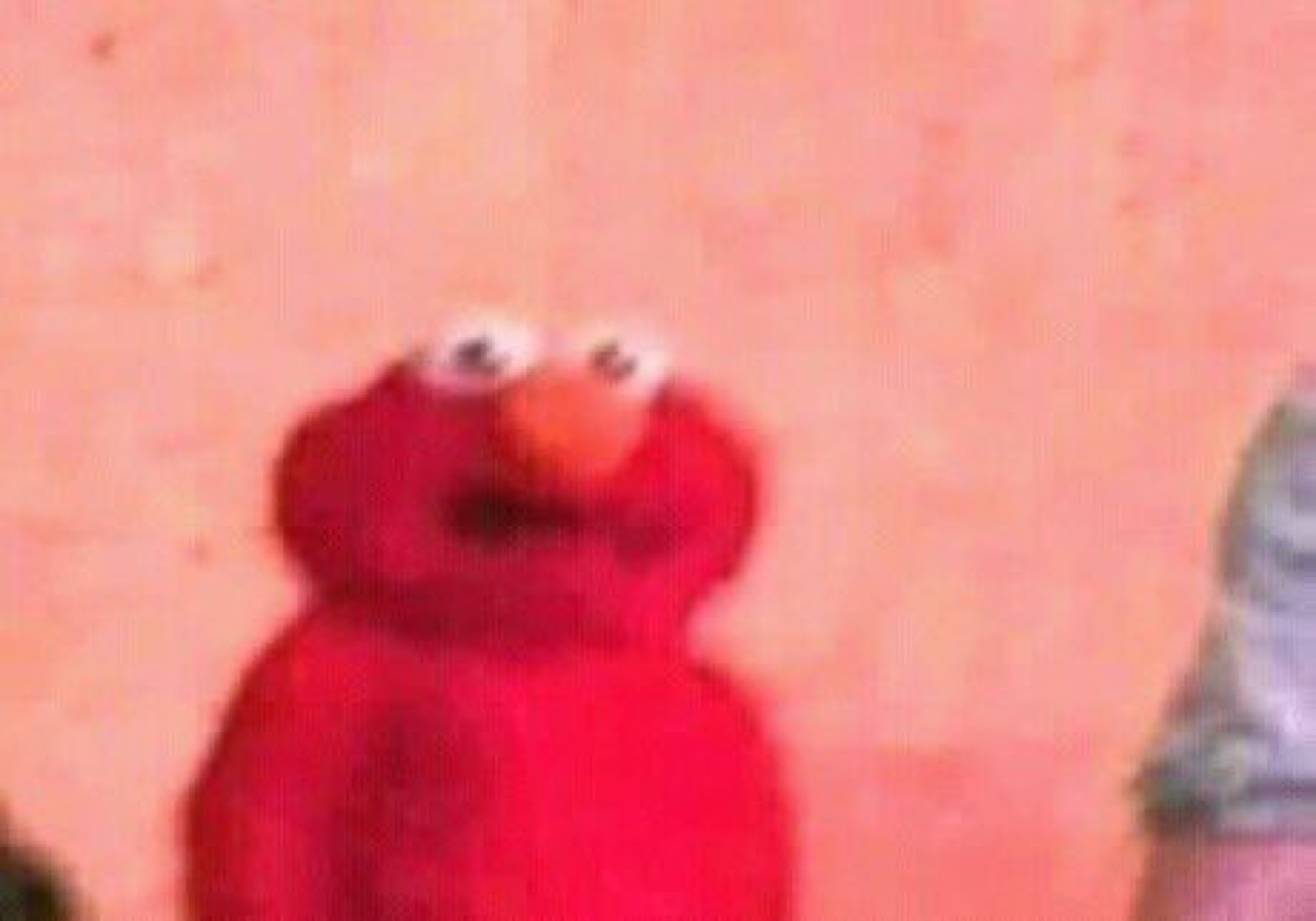Elmo staring into the distance with a bewildered, slightly unsettled look