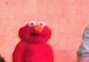 Elmo staring into the distance with a bewildered, slightly unsettled look