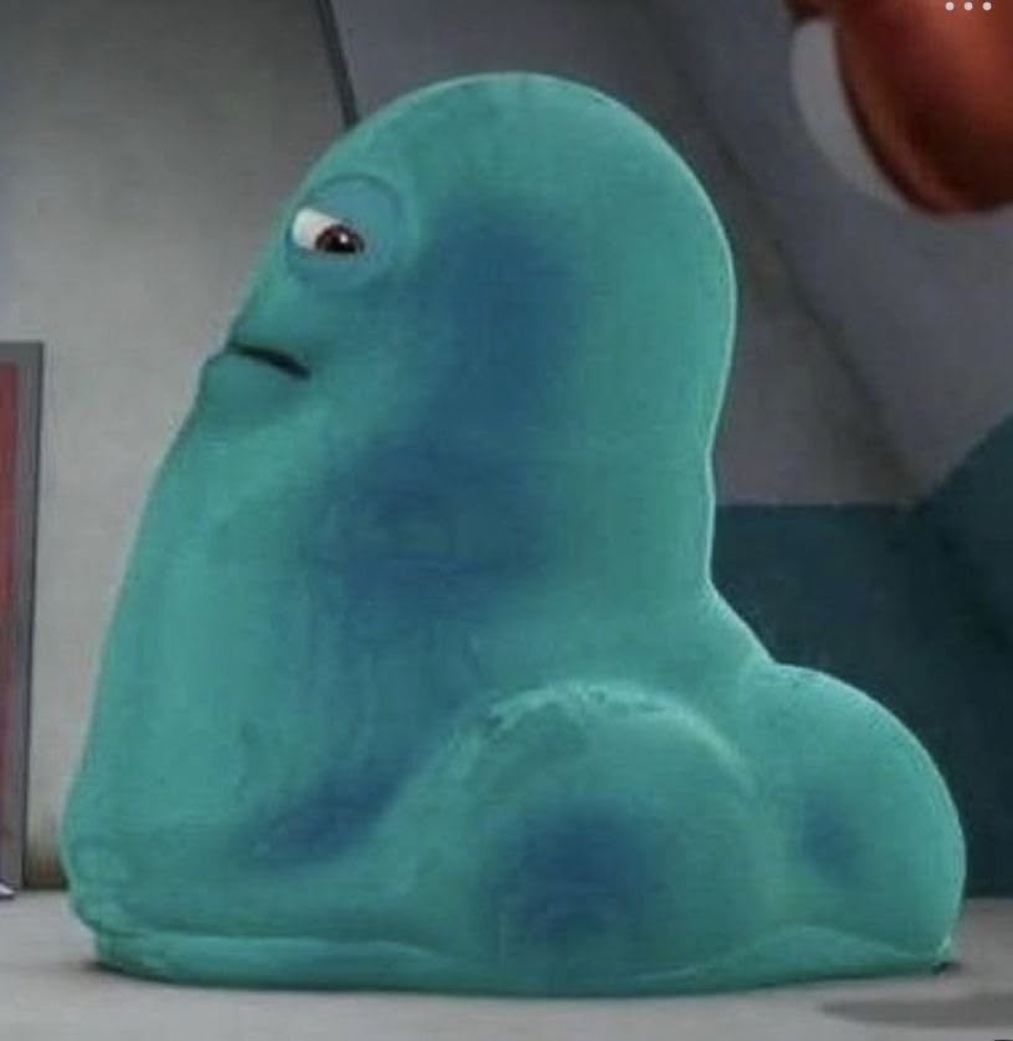Blue blob monster giving a slow sideways glance