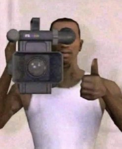 Video game character filming with a camcorder while giving a big thumbs up