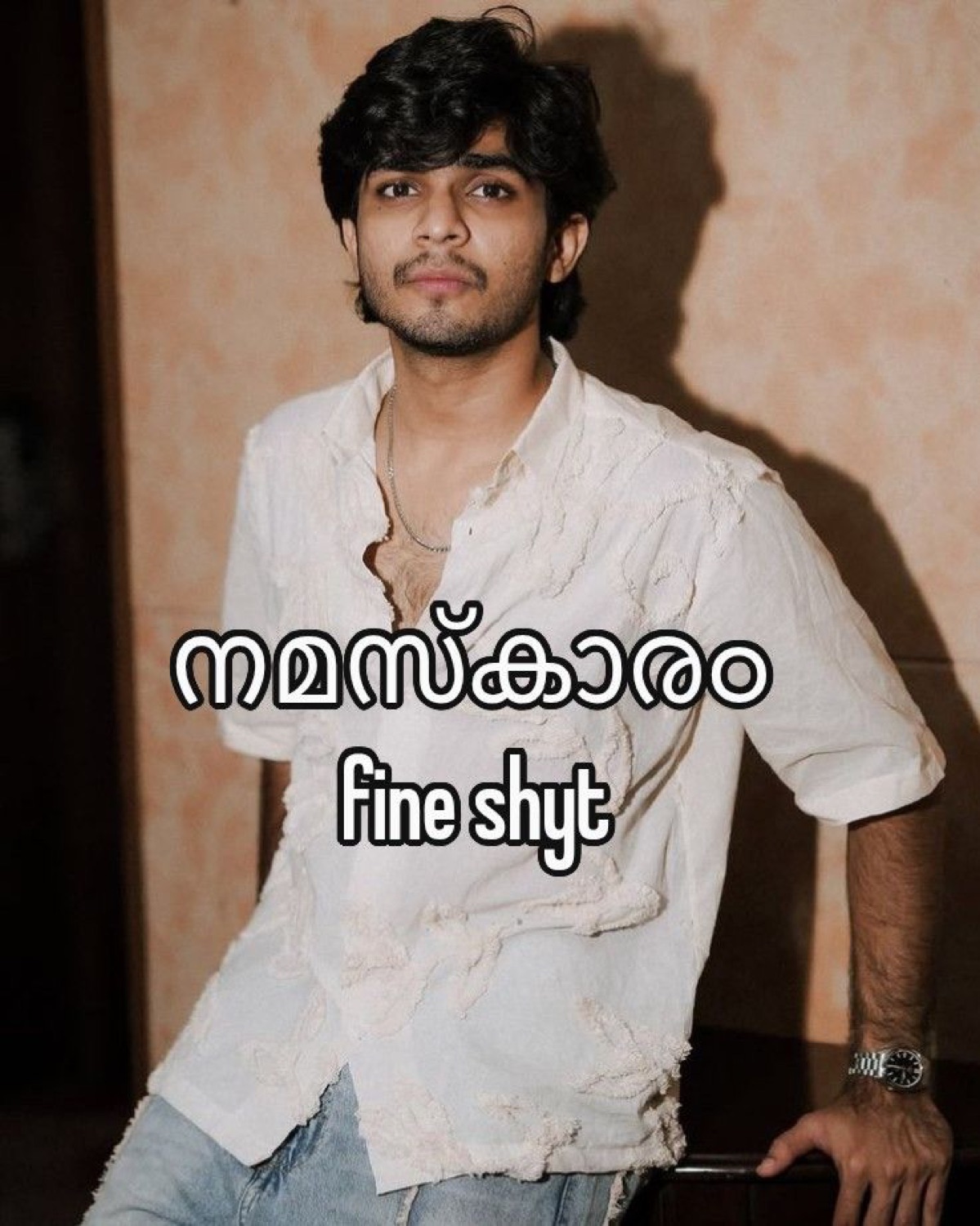 Man posing: 'നമസ്കാരം Fine shyt' (hello, fine shyt)