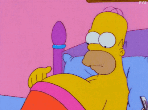 Homer Simpson lying in bed rubbing his belly