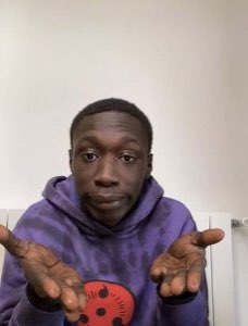 Khaby Lame doing his palms-up 'obviously' shrug