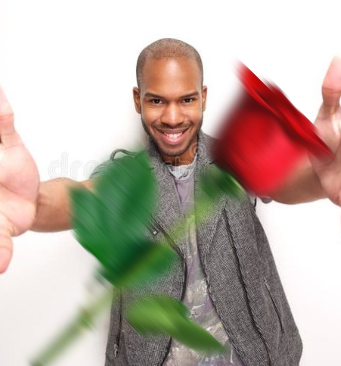 Grinning man in a grey vest shoving a blurry red rose at the camera