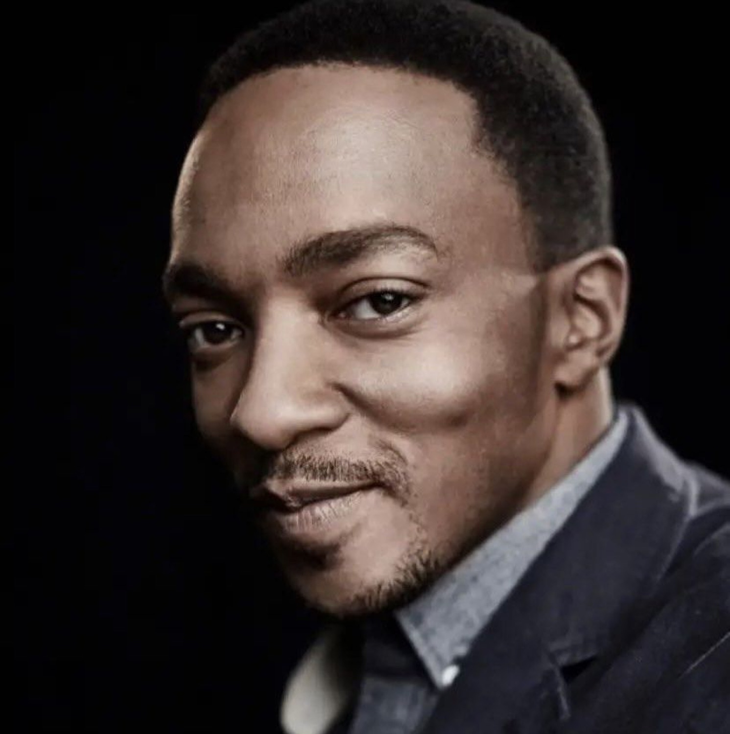 Man in a suit giving a subtle, smug, confident half-smile